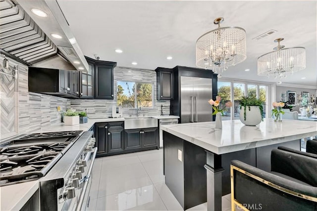 kitchen featuring custom exhaust hood, a center island, high end appliances, sink, and pendant lighting