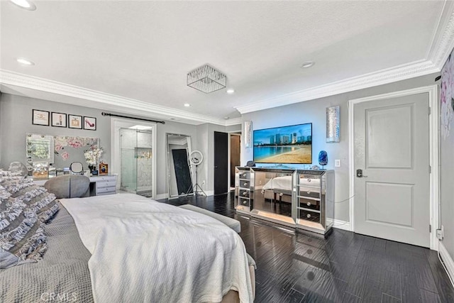 bedroom with crown molding and dark hardwood / wood-style floors