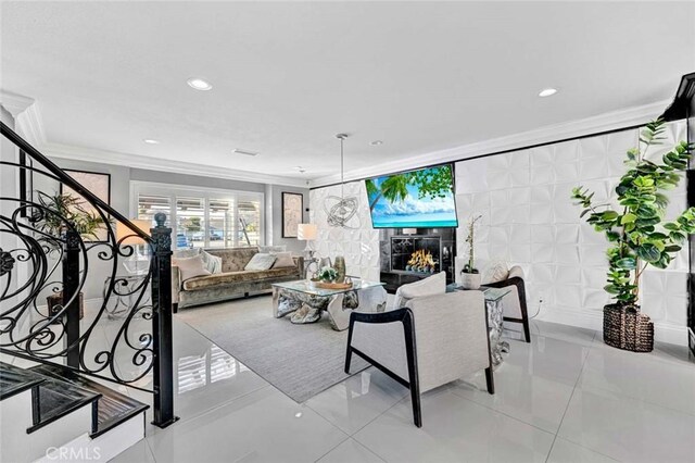 tiled living room featuring a tile fireplace and ornamental molding