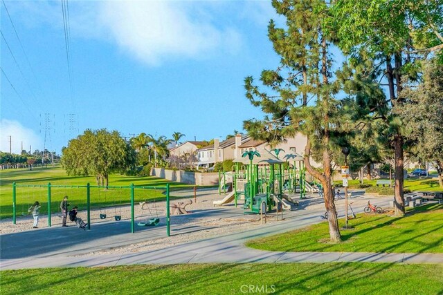 view of property's community with a playground and a lawn