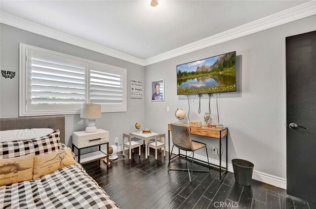 sitting room with crown molding and dark wood-type flooring