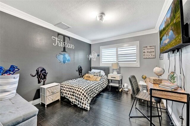 bedroom featuring crown molding, a textured ceiling, and dark hardwood / wood-style flooring