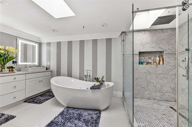 bathroom featuring ornamental molding, separate shower and tub, a skylight, and vanity