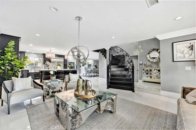 living room with crown molding, an inviting chandelier, and light tile patterned floors