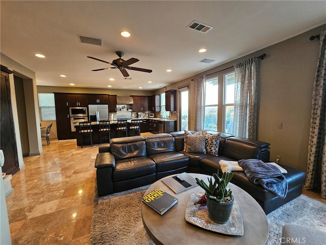 living area featuring recessed lighting, visible vents, and ceiling fan