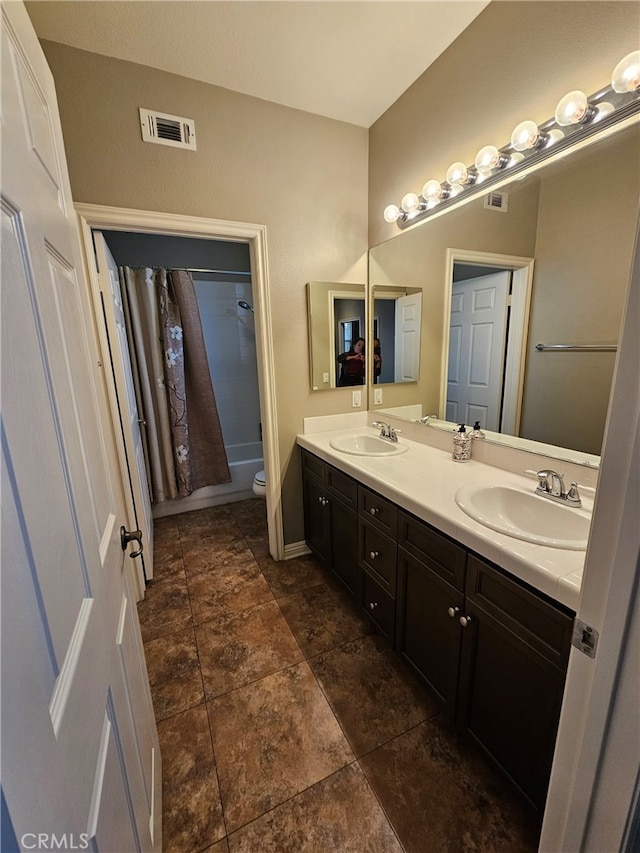 bathroom with toilet, shower / bath combo, double vanity, and a sink