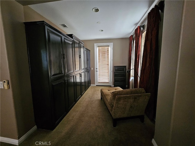 interior space featuring baseboards, visible vents, and carpet flooring