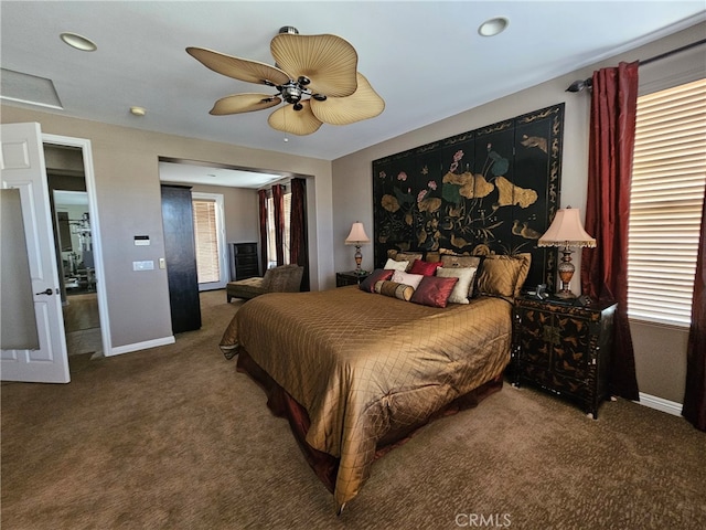 carpeted bedroom featuring ceiling fan and baseboards