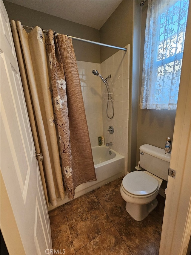 bathroom featuring shower / bath combination with curtain and toilet