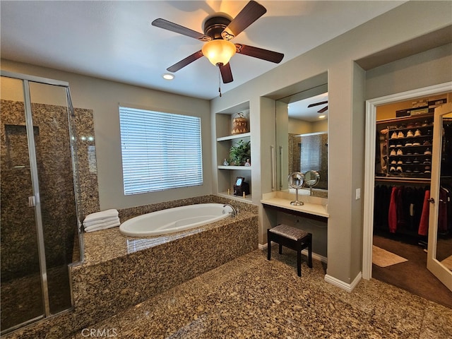 full bathroom featuring baseboards, a garden tub, a walk in closet, a shower stall, and built in shelves