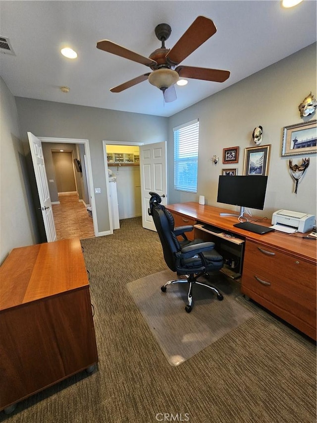 office space featuring ceiling fan, carpet floors, visible vents, and baseboards