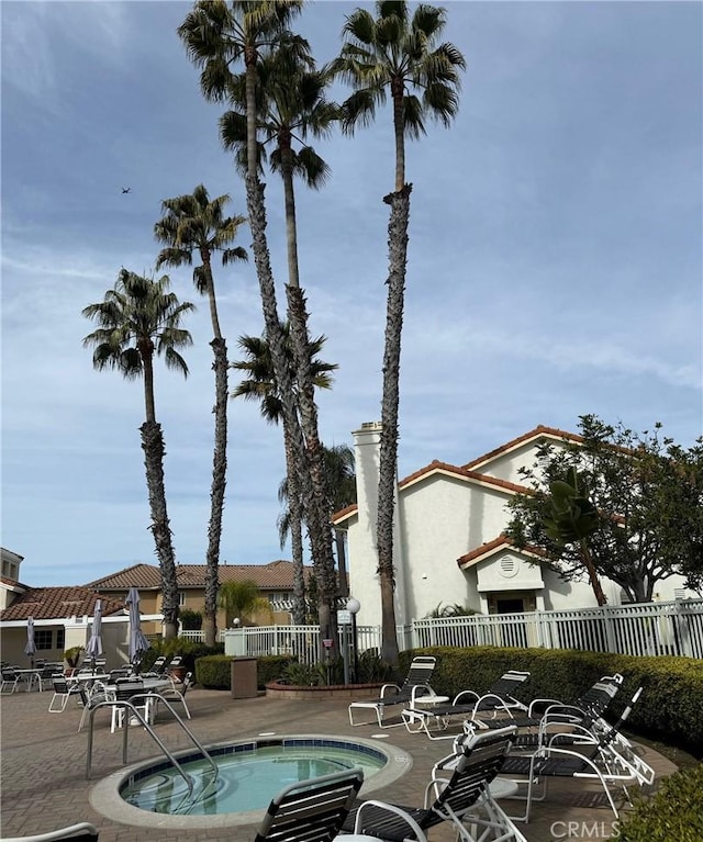 view of pool with an in ground hot tub and a patio