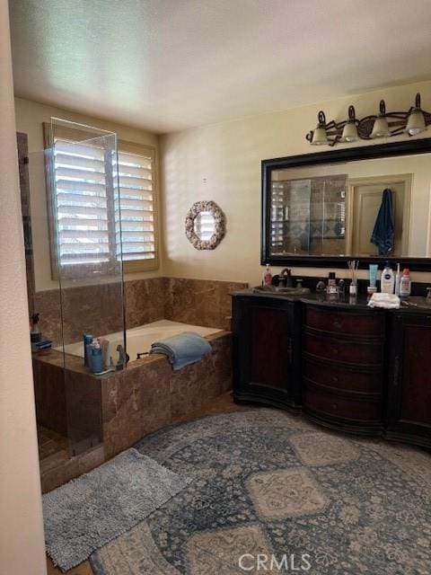 bathroom featuring vanity and shower with separate bathtub