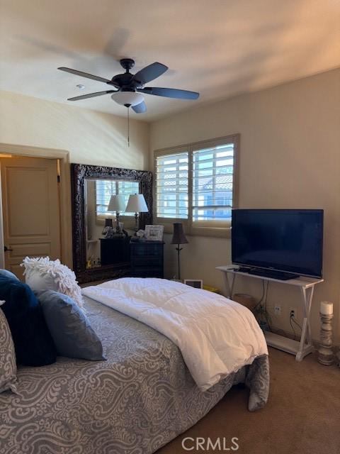 carpeted bedroom with ceiling fan