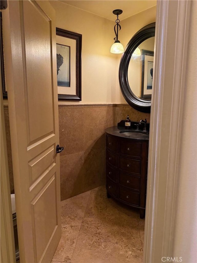 bathroom featuring tile walls and vanity