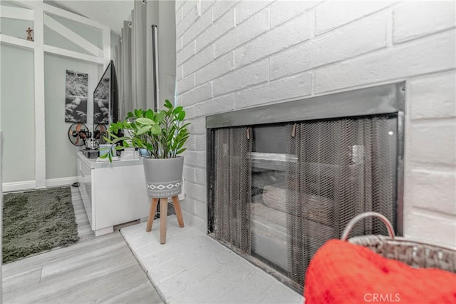 room details featuring a fireplace and hardwood / wood-style floors