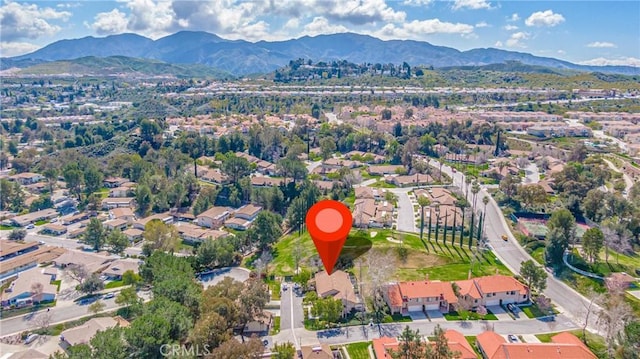 birds eye view of property featuring a mountain view