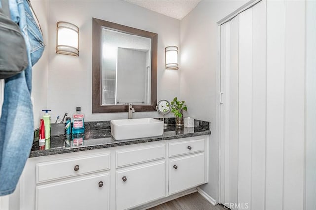 bathroom with vanity and a textured ceiling