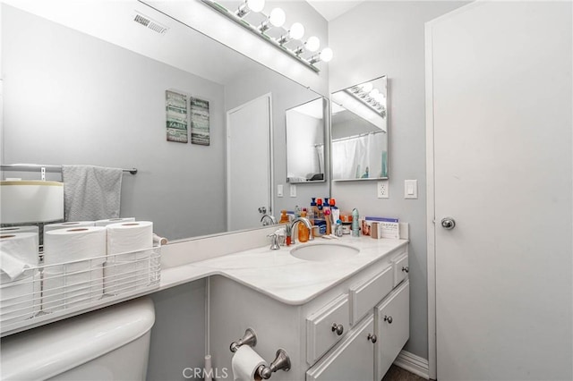 bathroom featuring toilet and vanity