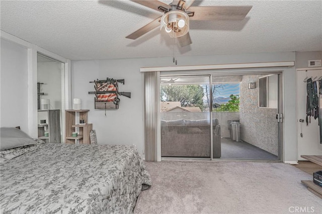 carpeted bedroom with ceiling fan, a textured ceiling, and access to outside