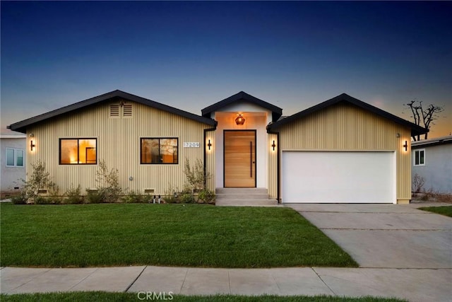 view of front facade with a garage and a lawn