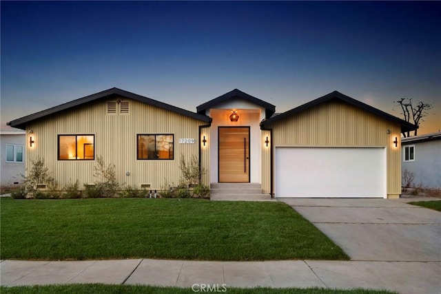 view of front of home featuring an attached garage, crawl space, concrete driveway, and a front yard