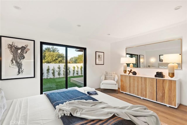 bedroom featuring access to exterior and light hardwood / wood-style floors