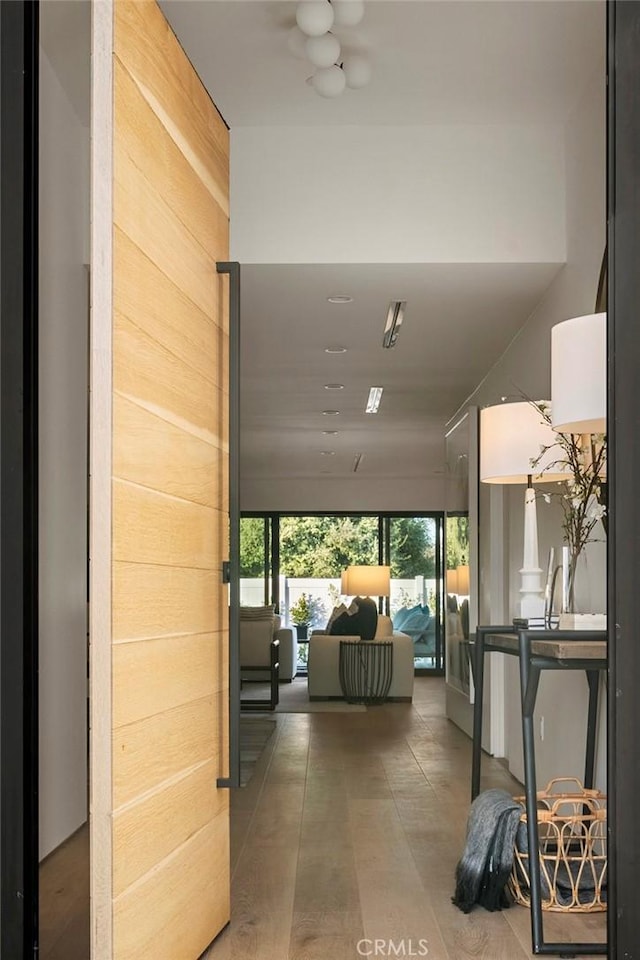 hallway featuring wood walls