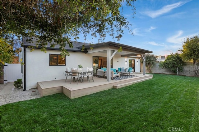 back of house with a wooden deck, an outdoor hangout area, and a lawn