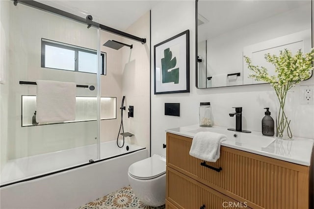 full bathroom featuring toilet, enclosed tub / shower combo, and vanity