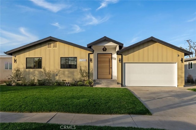 view of front of home with a garage and a front yard