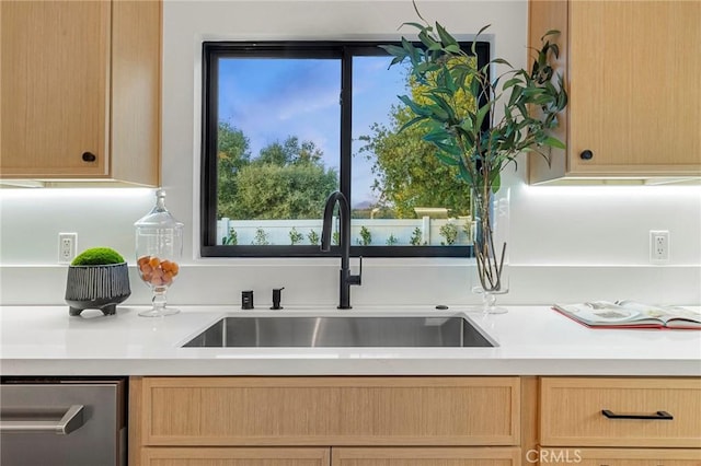 kitchen featuring light countertops, a sink, dishwasher, and light brown cabinetry