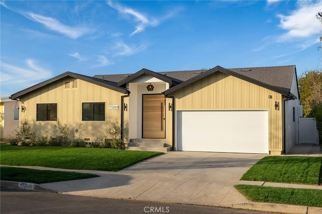 ranch-style house with an attached garage, driveway, and a front yard