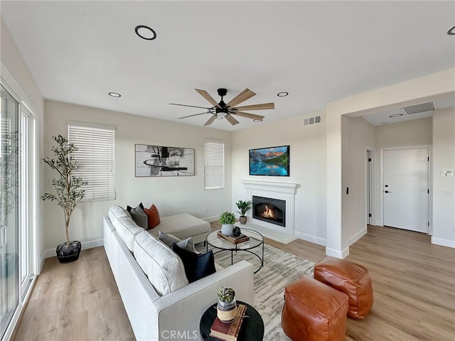 living room featuring hardwood / wood-style flooring and ceiling fan