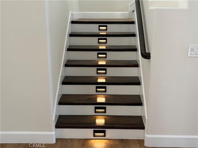 staircase featuring hardwood / wood-style flooring