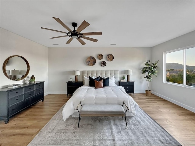 bedroom with light wood-type flooring and ceiling fan