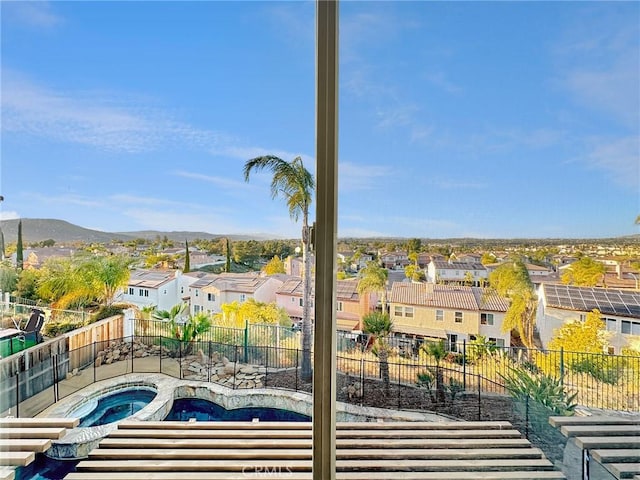 view of swimming pool featuring a mountain view and an in ground hot tub