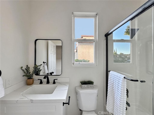 bathroom with vanity, toilet, and walk in shower