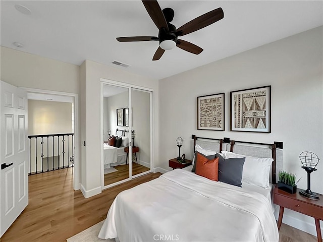 bedroom with ceiling fan, hardwood / wood-style floors, and a closet