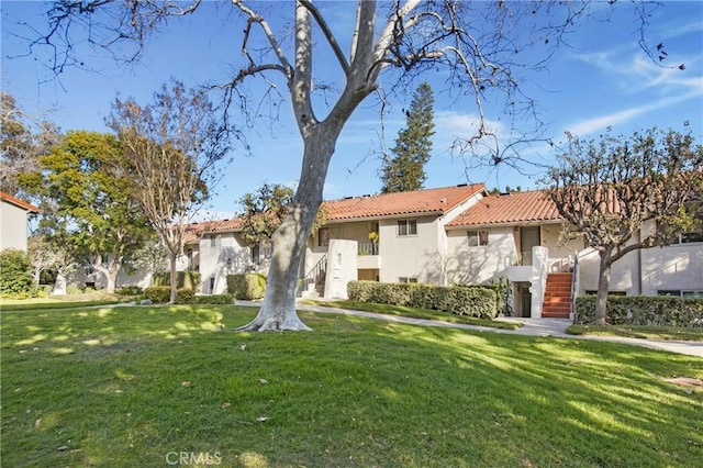 mediterranean / spanish house featuring a front lawn