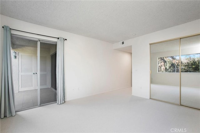 unfurnished room featuring a textured ceiling