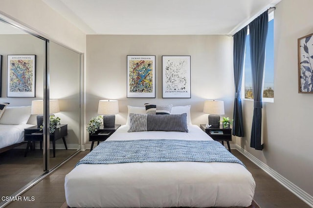 bedroom with dark hardwood / wood-style floors and a closet