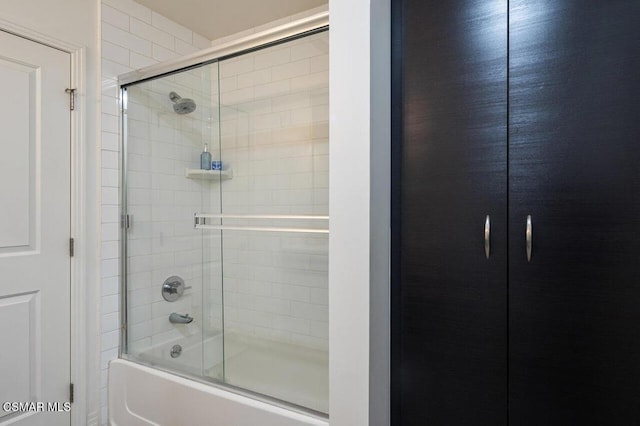 bathroom featuring shower / bath combination with glass door