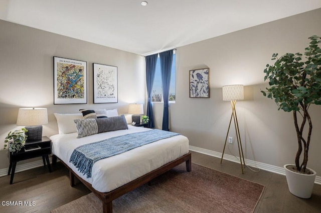 bedroom with dark wood-type flooring