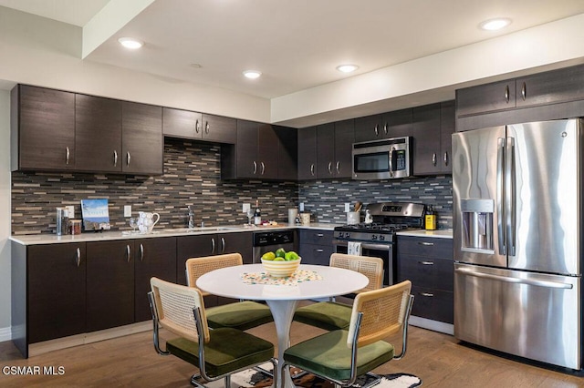 kitchen featuring sink, backsplash, dark brown cabinetry, and stainless steel appliances