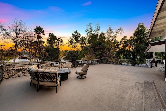 patio terrace at dusk featuring outdoor lounge area