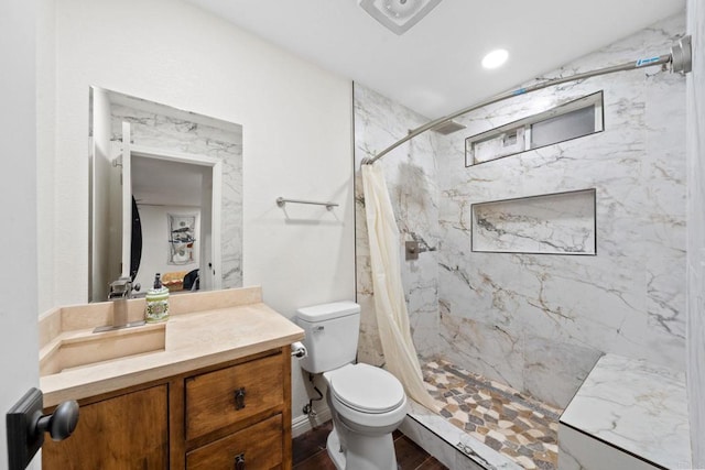 bathroom featuring vanity, toilet, and curtained shower