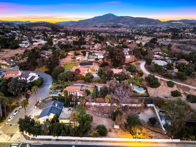 aerial view at dusk featuring a mountain view