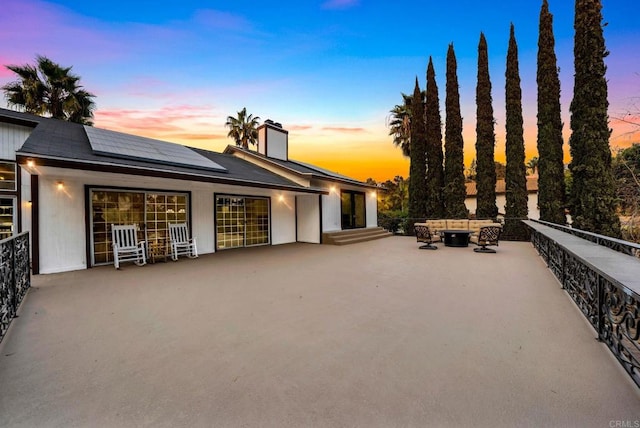 patio terrace at dusk with an outdoor fire pit