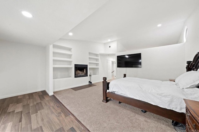 bedroom featuring hardwood / wood-style flooring and vaulted ceiling